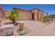 Inviting home with desert landscaping and an attached garage in a sunny neighborhood at 1702 W Amberwood Dr, Phoenix, AZ 85045