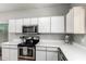 Kitchen with stainless steel microwave and oven, white cabinetry, and countertop appliances at 1702 W Amberwood Dr, Phoenix, AZ 85045