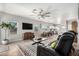 Bright open-concept living room featuring a modern sofa and views of the dining and kitchen areas at 1702 W Amberwood Dr, Phoenix, AZ 85045