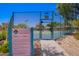 Exterior of a tennis court with rules, fencing, and view of the community at 1702 W Amberwood Dr, Phoenix, AZ 85045