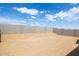 A view of the backyard showcasing the yard and block wall at 17743 W Onyx Ave, Waddell, AZ 85355