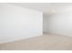 Bright bedroom featuring neutral carpet, white walls, and ample natural light at 17743 W Onyx Ave, Waddell, AZ 85355