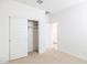 Carpeted bedroom featuring closet with sliding doors at 17743 W Onyx Ave, Waddell, AZ 85355