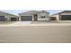 Charming single-story home featuring a gray color scheme, a two-car garage and minimalist landscaping at 17743 W Onyx Ave, Waddell, AZ 85355