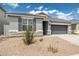 Beautiful single-story house showcasing a gray façade, a two-car garage, and stone veneer accents at 17743 W Onyx Ave, Waddell, AZ 85355