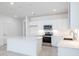 Contemporary kitchen featuring white cabinets, stainless steel appliances, and a functional center island at 17743 W Onyx Ave, Waddell, AZ 85355