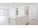 Open-concept kitchen with white cabinets, a large center island, and neutral-toned flooring at 17743 W Onyx Ave, Waddell, AZ 85355