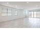 Bright living room featuring tiled floors, multiple windows, and access to a patio at 17743 W Onyx Ave, Waddell, AZ 85355