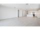 Spacious open-plan living area with tile flooring, with adjacent kitchen and dining area at 17743 W Onyx Ave, Waddell, AZ 85355