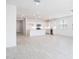 Expansive living area featuring tile flooring, recessed lighting, and kitchen in the background at 17743 W Onyx Ave, Waddell, AZ 85355
