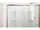 Modern glass-enclosed shower with built-in shelving for convenient storage of bath essentials at 17743 W Onyx Ave, Waddell, AZ 85355