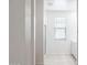 Bright bathroom with a tiled floor, glass-enclosed shower, and window providing natural light at 17773 W Onyx Ave, Waddell, AZ 85355