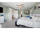 Spacious bedroom featuring a ceiling fan, neutral carpet, and adjacent access to the hallway at 17966 W Agave Rd, Goodyear, AZ 85338