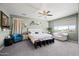 Large bedroom features plush carpeting, a sitting area, and natural light from a large window at 17966 W Agave Rd, Goodyear, AZ 85338