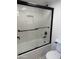 Updated bathroom with white subway tile shower/tub combo and black trim, plus modern fixtures at 1800 W Elliot Rd # 107, Chandler, AZ 85224