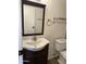 Bathroom with sink, dark wood cabinet and stylish fixtures and lighting at 1800 W Elliot Rd # 107, Chandler, AZ 85224