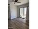 Bedroom featuring wood flooring and sliding glass doors for natural light at 1800 W Elliot Rd # 107, Chandler, AZ 85224