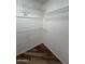 Walk-in closet with wood flooring and ample wire shelving for organized storage at 1800 W Elliot Rd # 107, Chandler, AZ 85224