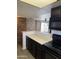 Kitchen with breakfast bar, tiled backsplash, open layout, and access to the living areas at 1800 W Elliot Rd # 107, Chandler, AZ 85224