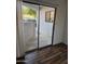 View to the patio through sliding glass doors, enhancing indoor-outdoor living with concrete slab and white exterior walls at 1800 W Elliot Rd # 107, Chandler, AZ 85224