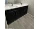 Bathroom vanity with double sinks, sleek black cabinets and lots of counter space at 1835 E Burgess Ln, Phoenix, AZ 85042