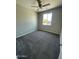 Bright bedroom featuring a large window that floods the room with natural light and plush carpeting at 1835 E Burgess Ln, Phoenix, AZ 85042