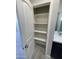 Bathroom closet featuring built-in shelving providing ample storage space at 1835 E Burgess Ln, Phoenix, AZ 85042