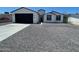 Beautifully renovated single-story home with a modern exterior, new garage door, and low-maintenance gravel yard at 1835 E Burgess Ln, Phoenix, AZ 85042