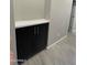 Hallway cabinet with storage space and sleek hardware on gray wood floors at 1835 E Burgess Ln, Phoenix, AZ 85042