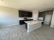 Modern kitchen featuring sleek dark cabinetry, stainless steel appliances, and a spacious center island at 1835 E Burgess Ln, Phoenix, AZ 85042