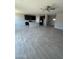 Spacious open-concept kitchen featuring a center island, gray wood-look tile, and dark cabinetry at 1835 E Burgess Ln, Phoenix, AZ 85042