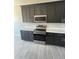 Kitchen with stainless steel appliances, dark wood cabinetry, and bright countertops at 1835 E Burgess Ln, Phoenix, AZ 85042