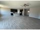 Spacious open-concept kitchen featuring a center island, gray wood-look tile, and dark cabinetry at 1835 E Burgess Ln, Phoenix, AZ 85042