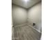 An empty laundry room with wood-look tile floors and washer and dryer hookups at 1835 E Burgess Ln, Phoenix, AZ 85042