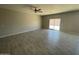 Large open living room featuring sleek flooring and a sliding door to the outside at 1835 E Burgess Ln, Phoenix, AZ 85042