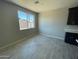 Neutral room featuring sleek floors, a large window offering abundant natural light, and crisp color palette at 1835 E Burgess Ln, Phoenix, AZ 85042