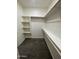 Walk-in closet featuring built-in shelving and hanging rods, providing ample storage space at 1835 E Burgess Ln, Phoenix, AZ 85042