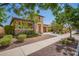 Desirable single-Gathering home featuring a two-car garage, stone accents, and mature desert landscaping at 20499 W Alsap Rd, Buckeye, AZ 85396