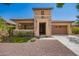 Attractive single-Gathering home featuring a two-car garage, stone accents, and desert landscaping at 20499 W Alsap Rd, Buckeye, AZ 85396
