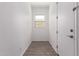 Entry hallway with gray floors, white walls, and a door to the side at 20499 W Alsap Rd, Buckeye, AZ 85396