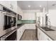 This bright kitchen features an island with seating, stainless steel appliances, and gas cooktop at 20499 W Alsap Rd, Buckeye, AZ 85396
