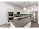 Modern kitchen featuring stainless steel appliances, a large island with a gray countertop and stylish subway tile backsplash at 20499 W Alsap Rd, Buckeye, AZ 85396