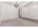 Bright living room featuring carpet, neutral paint and a decorative chandelier at 20499 W Alsap Rd, Buckeye, AZ 85396