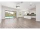 Open living room with tile flooring, a ceiling fan, and a sliding glass door at 20499 W Alsap Rd, Buckeye, AZ 85396