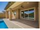 Covered patio featuring a ceiling fan and sliding glass doors overlooking the sparkling pool at 20499 W Alsap Rd, Buckeye, AZ 85396