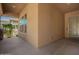 Covered front porch with neutral paint, tile floor, windows and door at 20499 W Alsap Rd, Buckeye, AZ 85396
