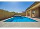Backyard pool with integrated spa, set against a backdrop of blue skies and privacy walls at 20499 W Alsap Rd, Buckeye, AZ 85396