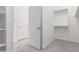 Walk-in closet with carpet flooring, and white shelving and hanging rods at 20499 W Alsap Rd, Buckeye, AZ 85396