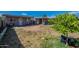 Backyard featuring grassy areas and detached structures, providing space for outdoor activities and storage at 2103 N Silverton St, Mesa, AZ 85203