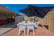Inviting backyard featuring a patio with an umbrella-covered table, perfect for outdoor dining and relaxation at 2103 N Silverton St, Mesa, AZ 85203